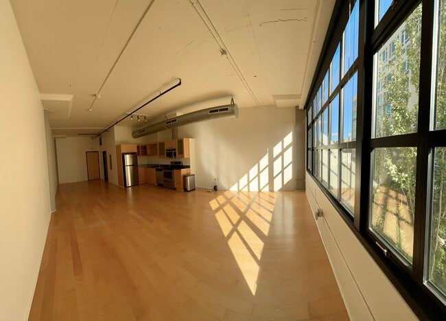 Full Loft, facing kitchen area and front door from exterior window -- no furnishing - 1400 NW Irving St Unit #514