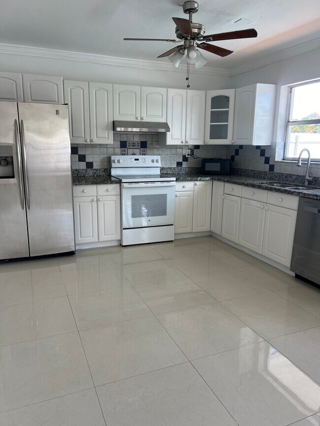 Open kitchen with stainless steel appliances, new refrigerator and plenty of space for storage - 2601 Acapulco Dr