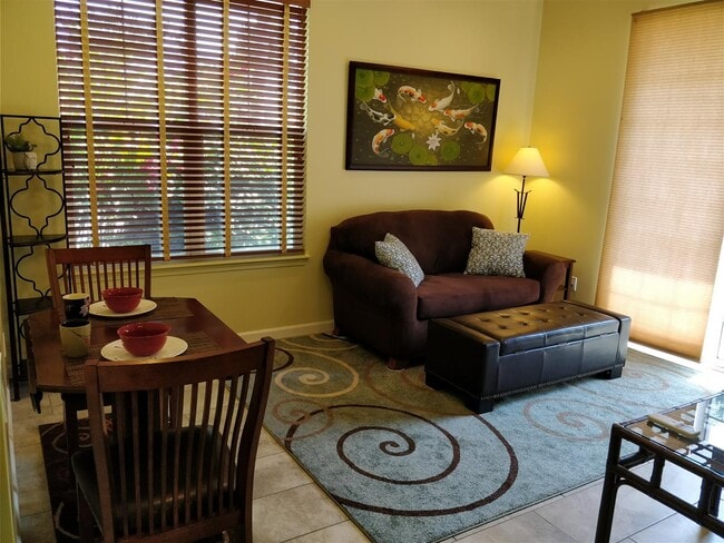 Living + Dining area now with tile and area rugs, not as yellow looking in real life