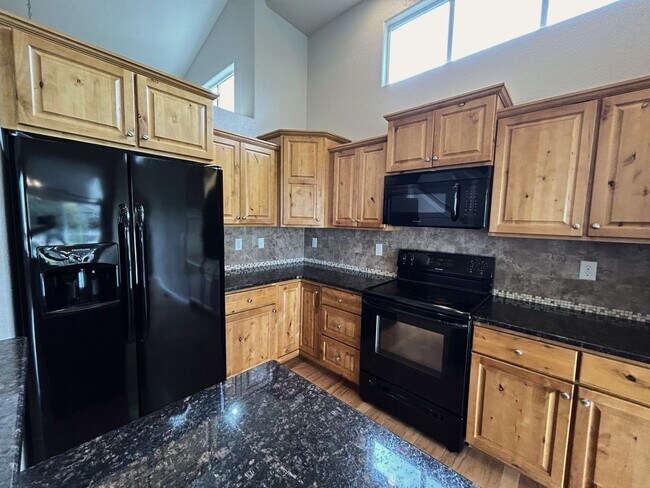 Photo - $500 Off First Month Of Rent! Modern 3BR Townhome with Fenced Yard & Garage