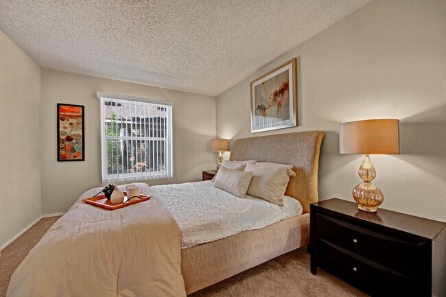 A bedroom with a window overlooking the property - Cypress Pointe