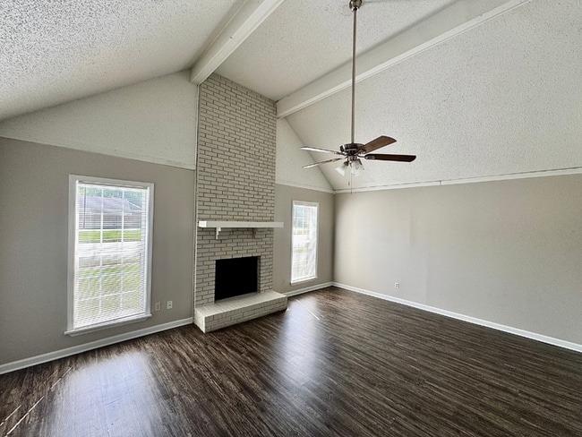 Photo - Charming 3BR/2BA Near Southwind | Soaring Vaulted Ceilings, Brick Fireplace & Fenced Yard