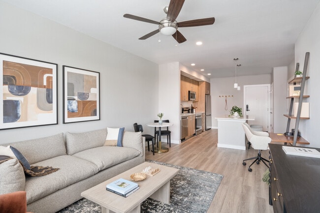 Living area with hard surface flooring and kitchen area