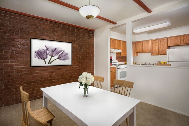 Separate dining area with exposed brick at Whitehall Square Apartments