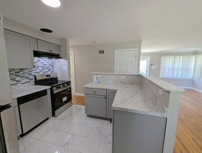 Photo - Updated Open-Concept with Sunroom & Finished Basement Space