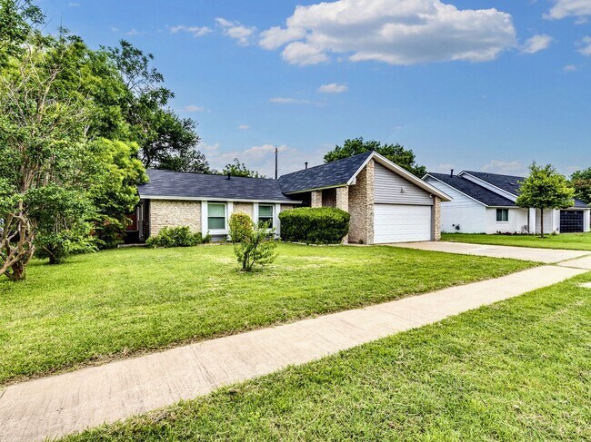 Photo - Charming 4BR / 2BA Home Featuring Fireplace, White Cabinets & Big Tree