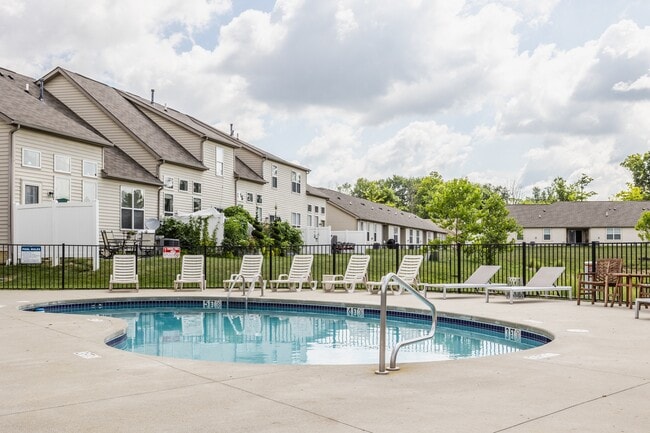 Dive into relaxation at our sparkling pool, surrounded by comfortable lounge chairs and scenic apartment views.