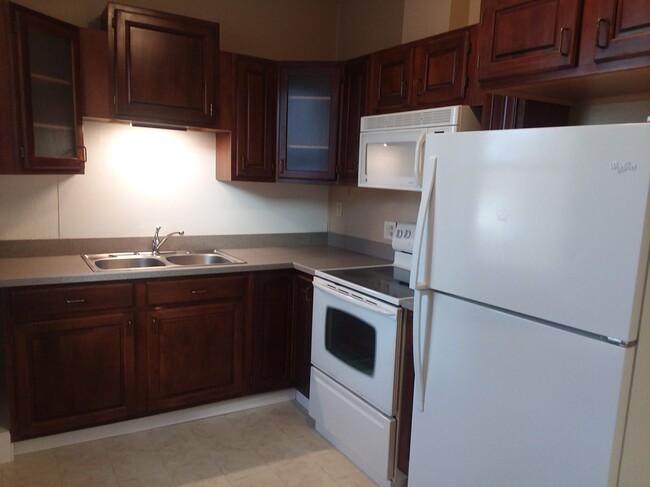 Cherry cabinet and Corian countertop - 1 East Main St. Unit Apt 1