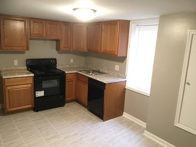 Open concept kitchen w/ dishwasher - Castle Manor Apartments