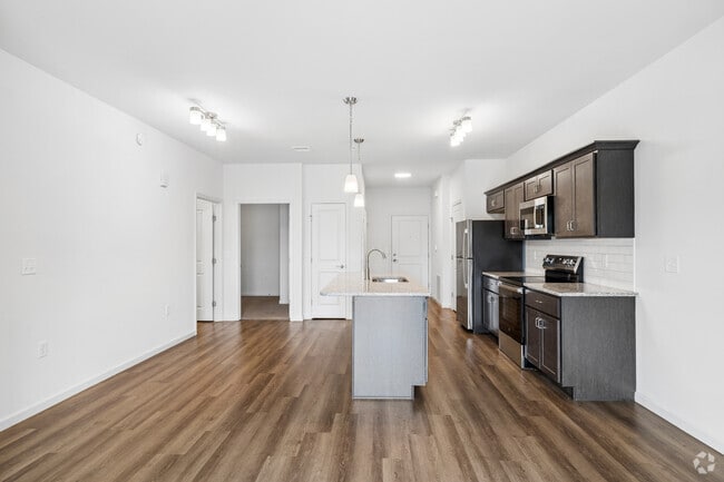 Madison 1BR, 1BA W/ Study - 942SF - Living Room and Kitchen - Red Mill Crossings
