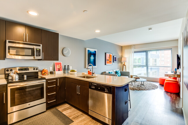 Open concept floorplan with kitchen view into living area - Zinc Apartments