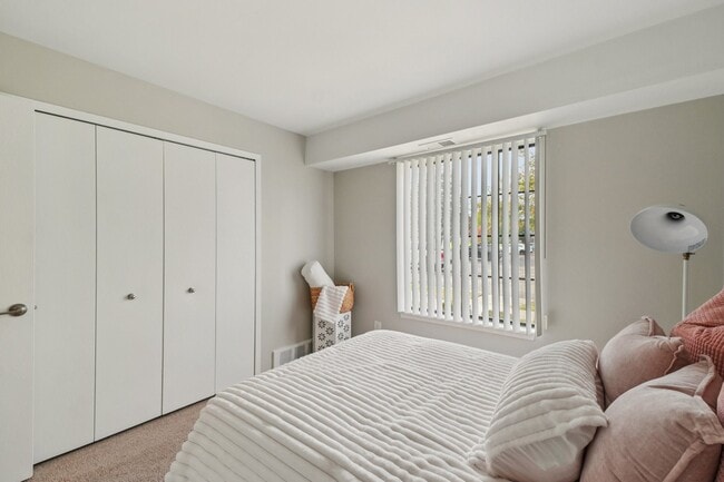 Relax in comfortable bedrooms featuring window blinds for privacy and light control, professionally operated by Highlands Vista Group.