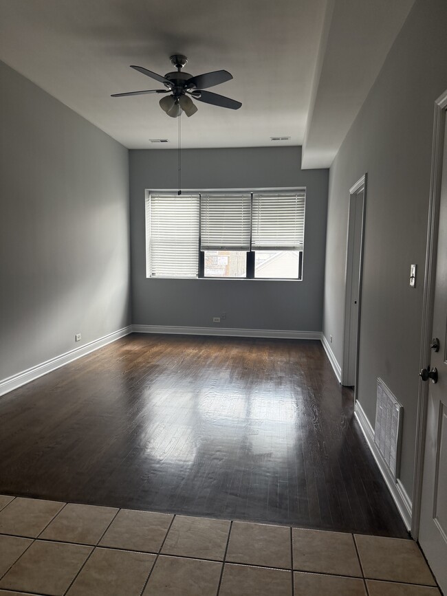 Inundada de luz natural, esta hermosa sala frontal le da la bienvenida con calidez desde el momento en que ingresa. - 930 W 35th Pl Unidad 2nd Floor Front