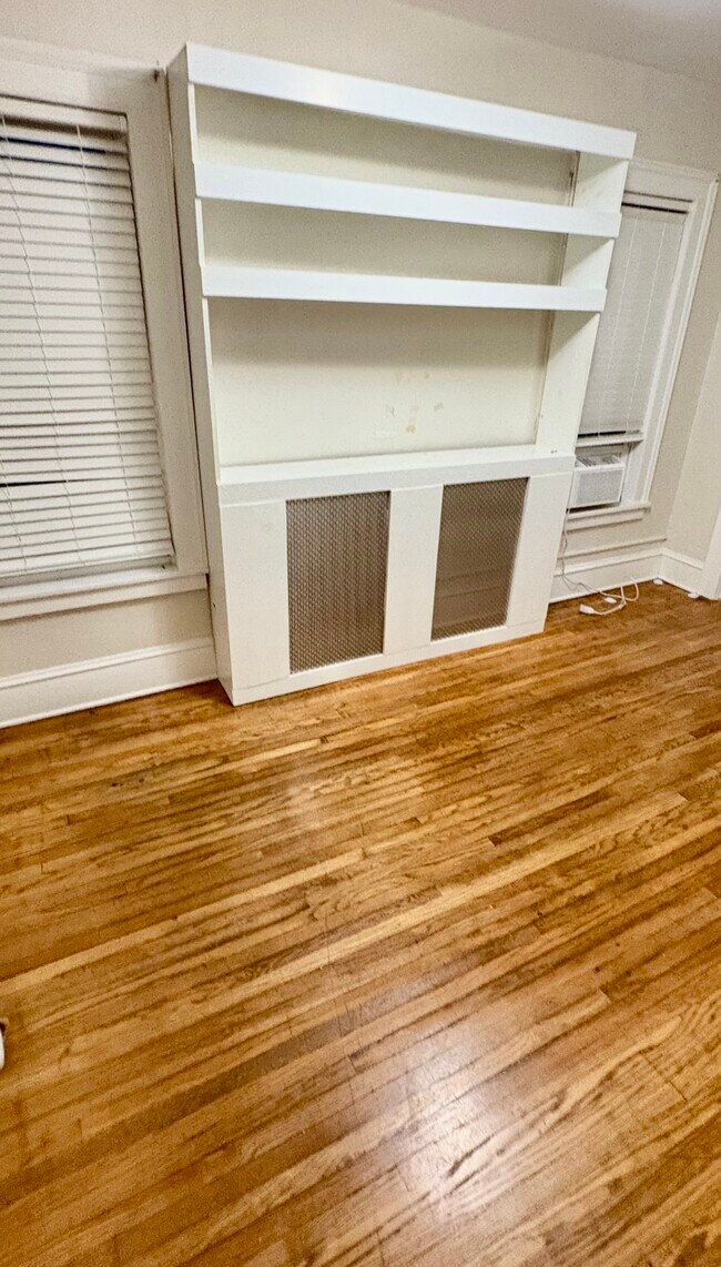 Living room with built-in entertainment center shelf - 52 Genesee St Unit Apartment 3