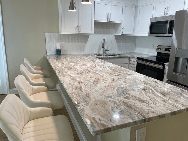 Updated kitchen with granite counters and stainless steel appliances - 2947 S Atlantic Ave Unit 301