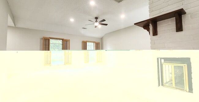Living room with recessed lighting and a featured white and maple brown fireplace