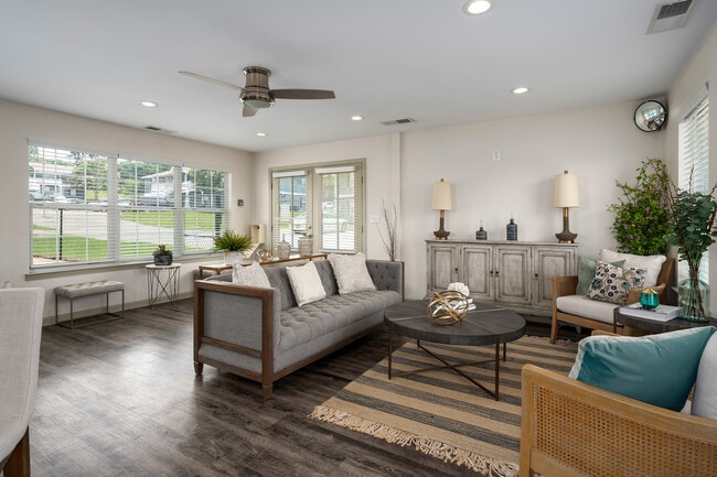Gather in our welcoming clubhouse featuring comfortable seating and coffee table for socializing, professionally operated by Highlands Vista Group.