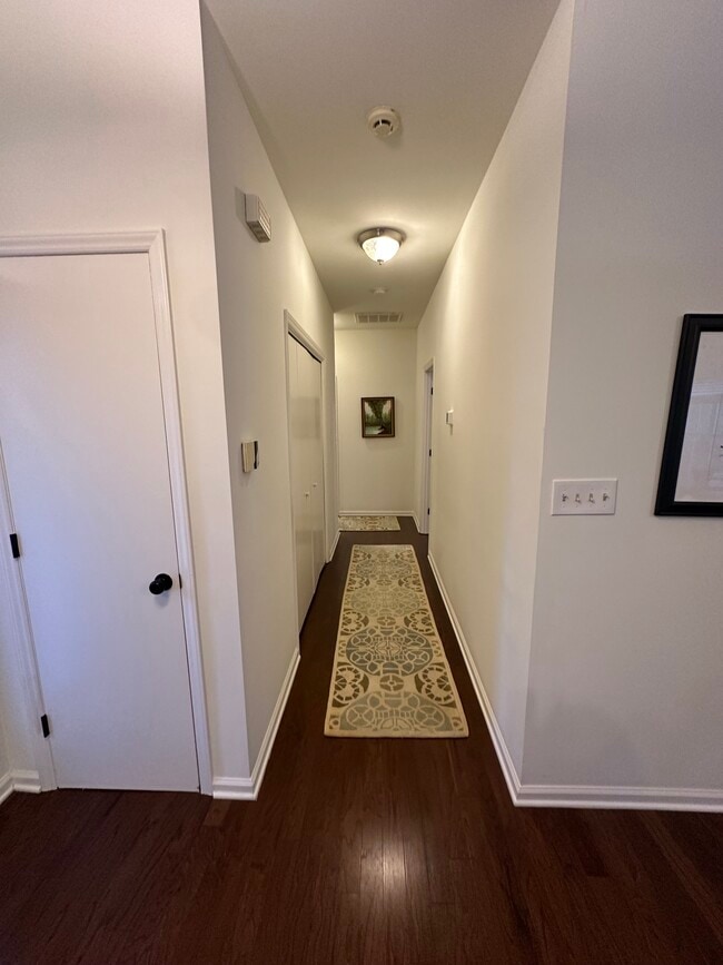 hallway to bedrooms and laundry closet - 3201 Gulfstream Ct