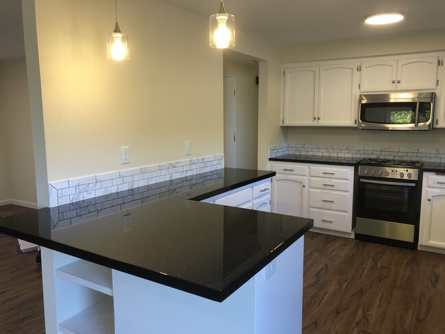 Newly updated kitchen with a large breakfast bar - 1889 12th Ave SW Casa