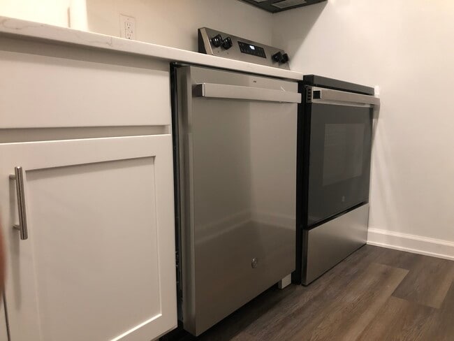 Modern range and dishwasher in updated kitchen. - 261 Simpson Ave Unit 226