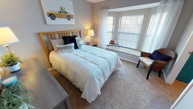 A naturally lighted bedroom with a window seat offers a warm and inviting retreat within the apartment. - Central Park Place