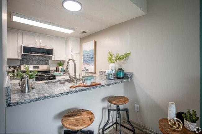 Bright kitchen with modern cabinetry and granite counters