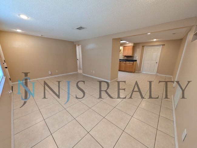 Photo - This 3/2/1 with over 1100 sq ft offers all tile floors open kitchen/dining, split floor plan on a...