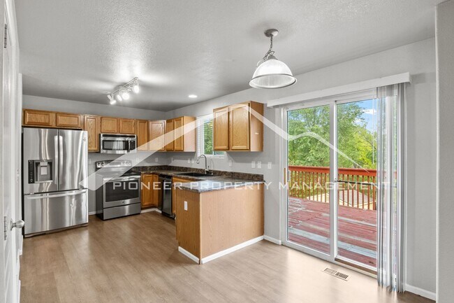 Photo - Spacious 4-Bed, 3.5-Bath Home with Walkout Basement, Oversized Deck enclosed yard, AC and 2-Car G...