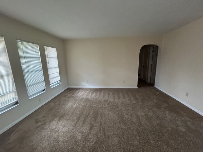 Photo - Freshly painted interior and new carpet in living room spacious home off Country Club Blvd