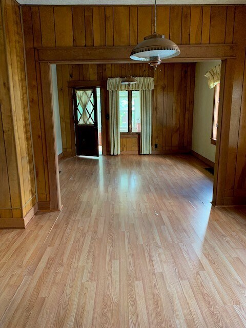 Looking from the dining room into the living room and front door