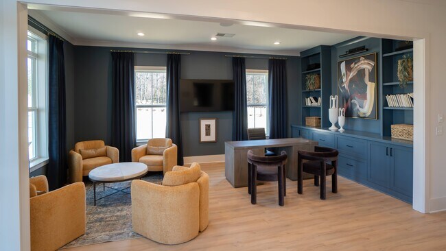 Clubhouse interior with leasing desk and relaxing sitting area.