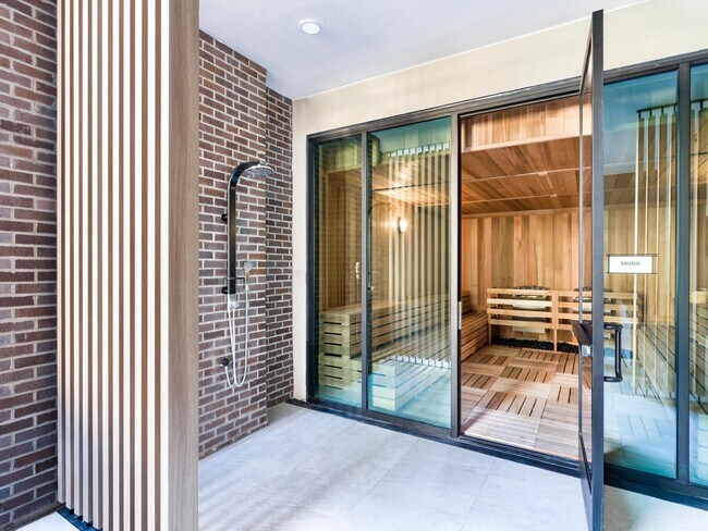 An on-site sauna with adjacent outdoor shower offers a refreshing wellness experience just steps from home.