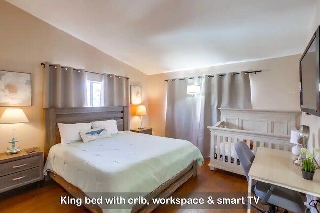 Unwind and recharge in this cloud-like king bed, with a crib for your little ones