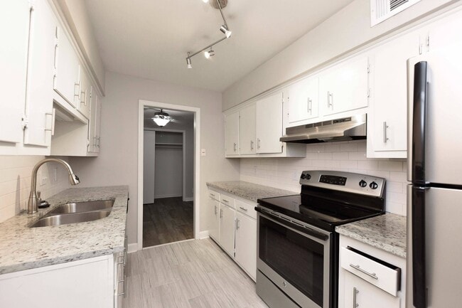 Kitchen with Backsplash + Modern Cabinetry - Greenbriar Apartments