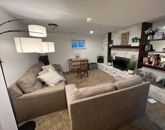 Living Room (Furnished, before new carpet) - 1632 S Sunset Dr Unit Basement Apartment