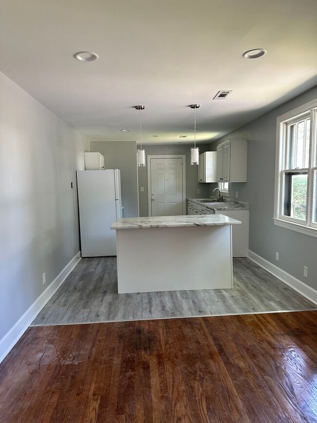 Open kitchen/den concept. - 1826 River Dr Unit Upstairs