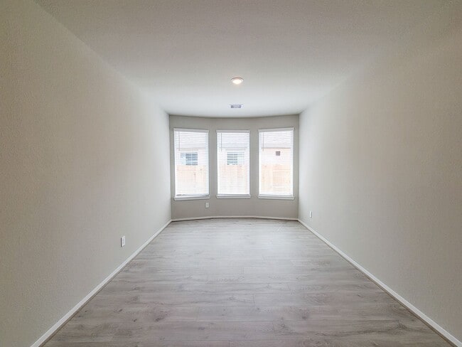 Photo - Single-story layout features a bright, open concept living area, dining space, and kitchen. Pebbl...