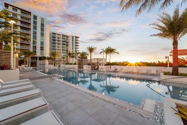 Sunset on The Bridge at Quantum Apartments palm lined pool deck.