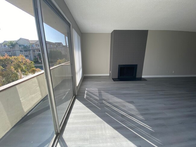 11858 Goshen Ave Unit 207 living room with fireplace and view
