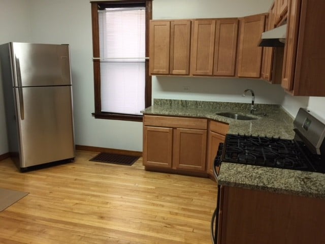 New kitchen with GRANITE TOPS and stainless steel appliances - 3748 W Lyndale St Unit 1st