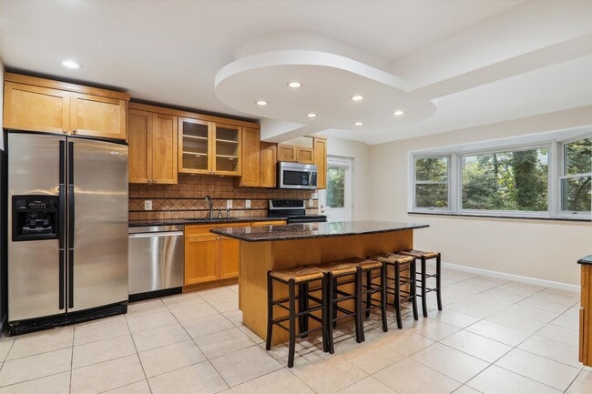 Photo - 5 BR 4.5 BA home with inground heated pool and extensive hardscape!