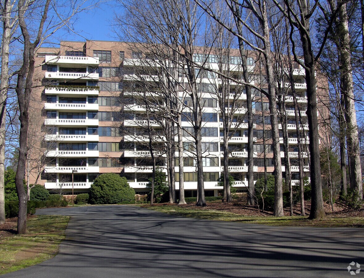 Looking north through the trees from the parking lot - Morrocroft Place Apartments