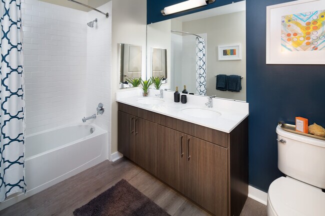 Avalon Package bath with espresso cabinetry, white quartz countertops and hard surface flooring