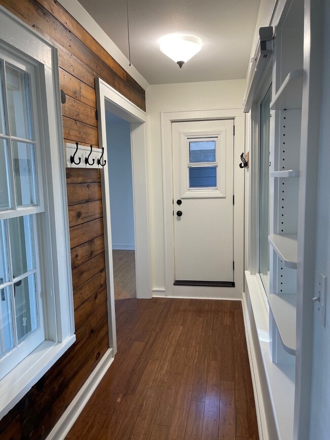 Entry hallway w/ original architectural elements, bamboo flooring & private front porch access. - 2650 S Shore Dr Unit Upper