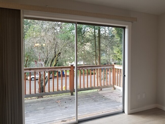 El salón tiene acceso a una amplia terraza con vistas a un bonito y tranquilo jardín delantero. - 4070 149th Ave SE Unidad 4070 149 th Ave SE