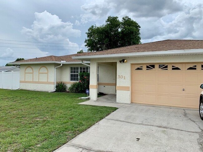 Photo - Available NOW! NEW FLOORS AND PAINT! Lovely 3/2 in Poinciana! HUGE fenced yard and NO CARPET!