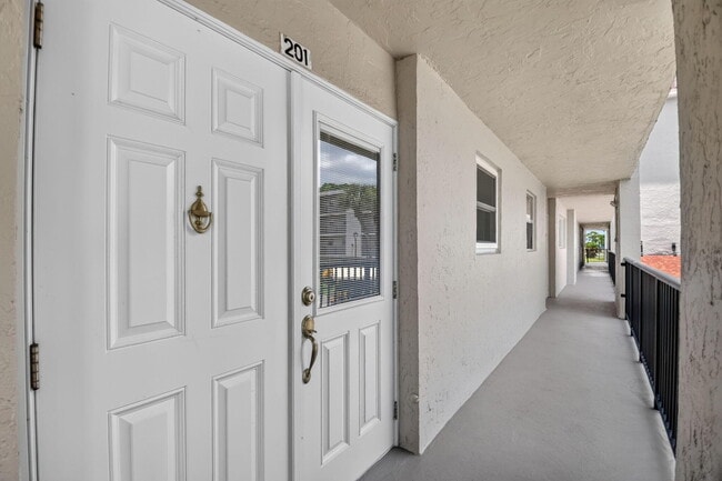 Building Photo - 3425 Via Poinciana Unit 201