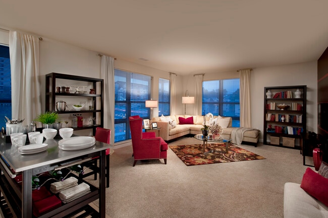 Open concept kitchen with movable island and living area with carpet