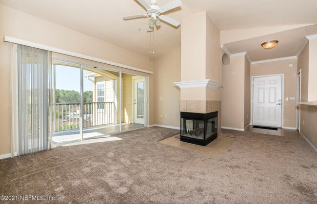 Family room w fireplace and sliding doors to screened terrace - 275 Old Village Center Cir Unit #6303