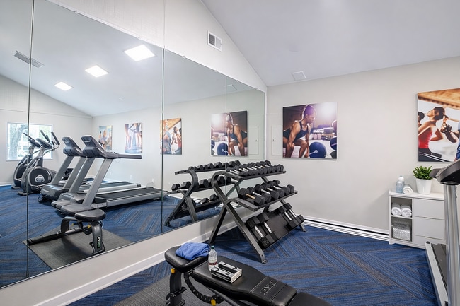 Modern fitness room with equipment and motivators